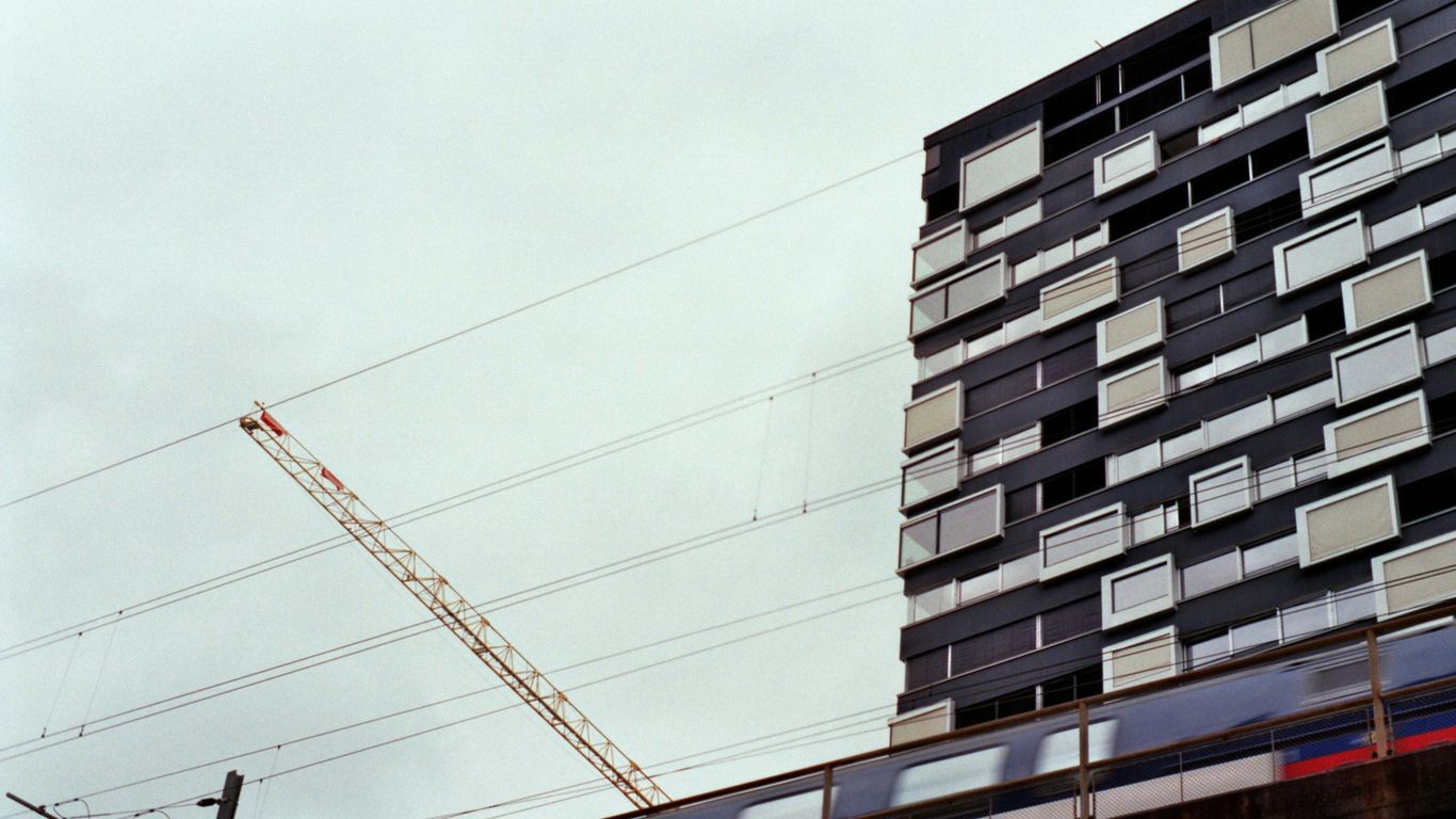 How Much Does a Home Extension Cost in Manchester? a crane next to a building